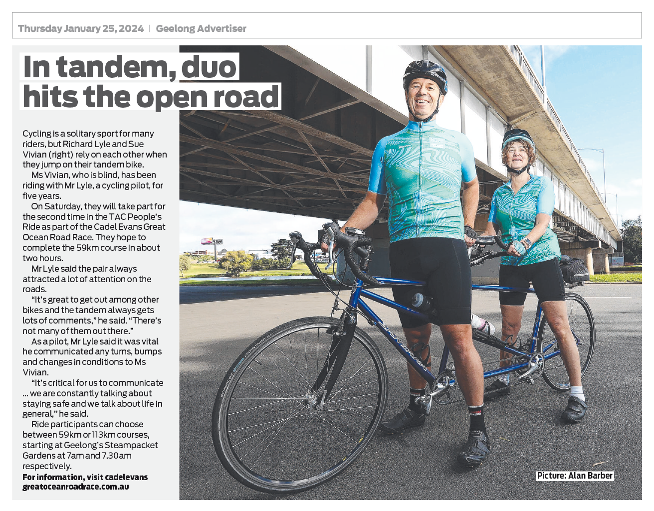 A newspaper clipping with text and an image of Rich and Sue on their stationary tandem bike, both with their feet on the ground. They are at the side of a wide road with a road bridge above and behind them. They are both smiling.
