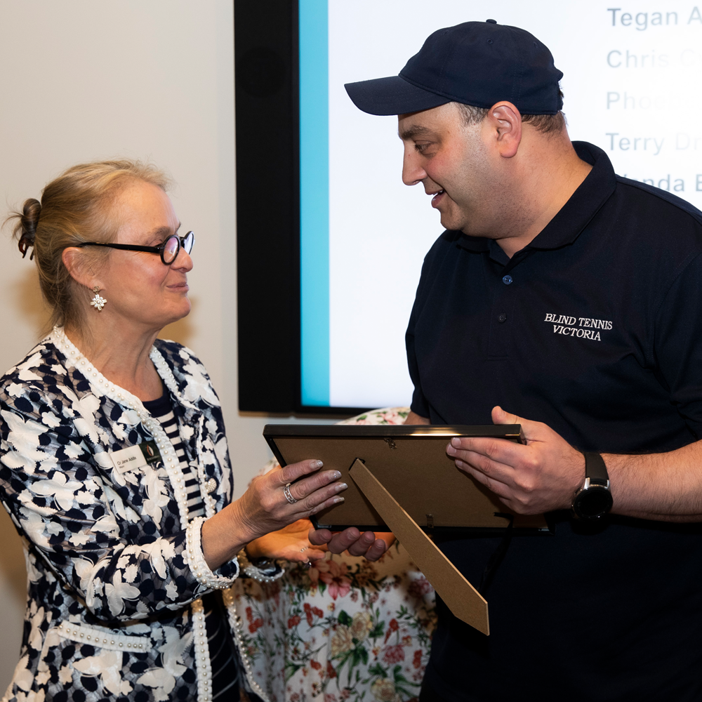 Photo of Adam Fayad receiving Ambassador Certificate